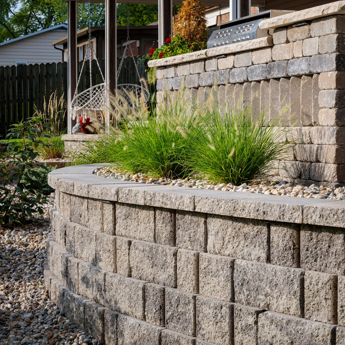 Custom engineered retaining wall installation near Memorial Houston with tiered stone blocks and drainage integration for Buffalo Bayou flood control